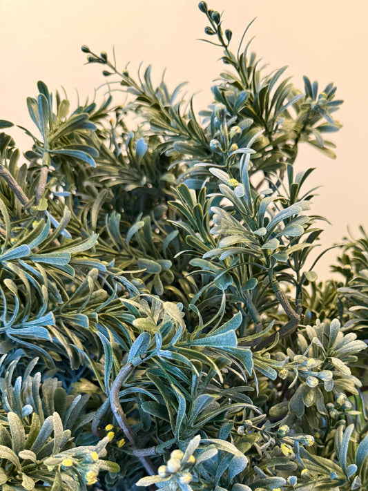 Close up of the Plantish artificial Artemisia’s green-grey leaves and detailed texture.
