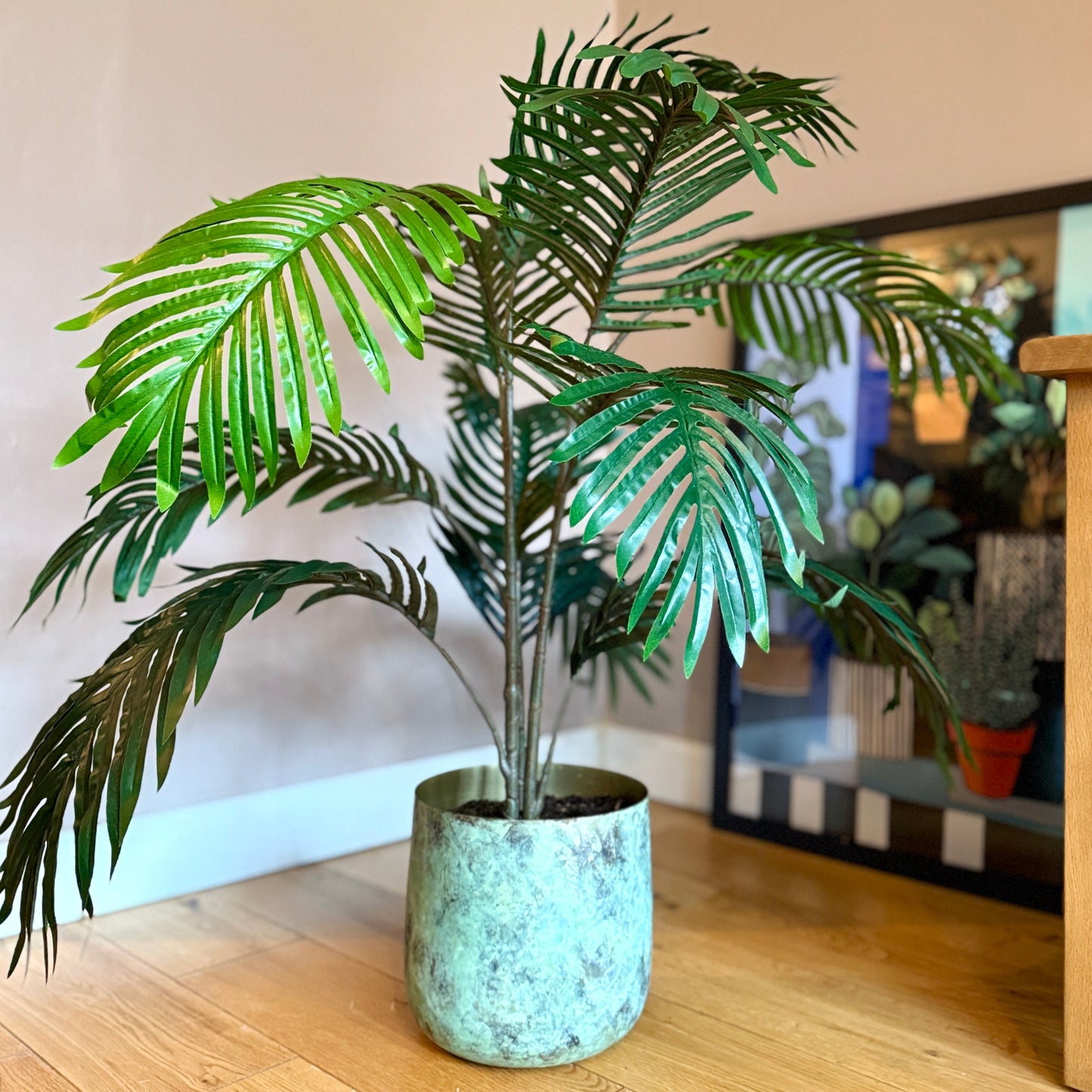 Back view of the Plantish artificial Areca Palm, highlighting the natural look of the detailed green fronds and simple stems. The full, symmetrical shape and lifelike design make it an ideal addition to any modern interior decor.