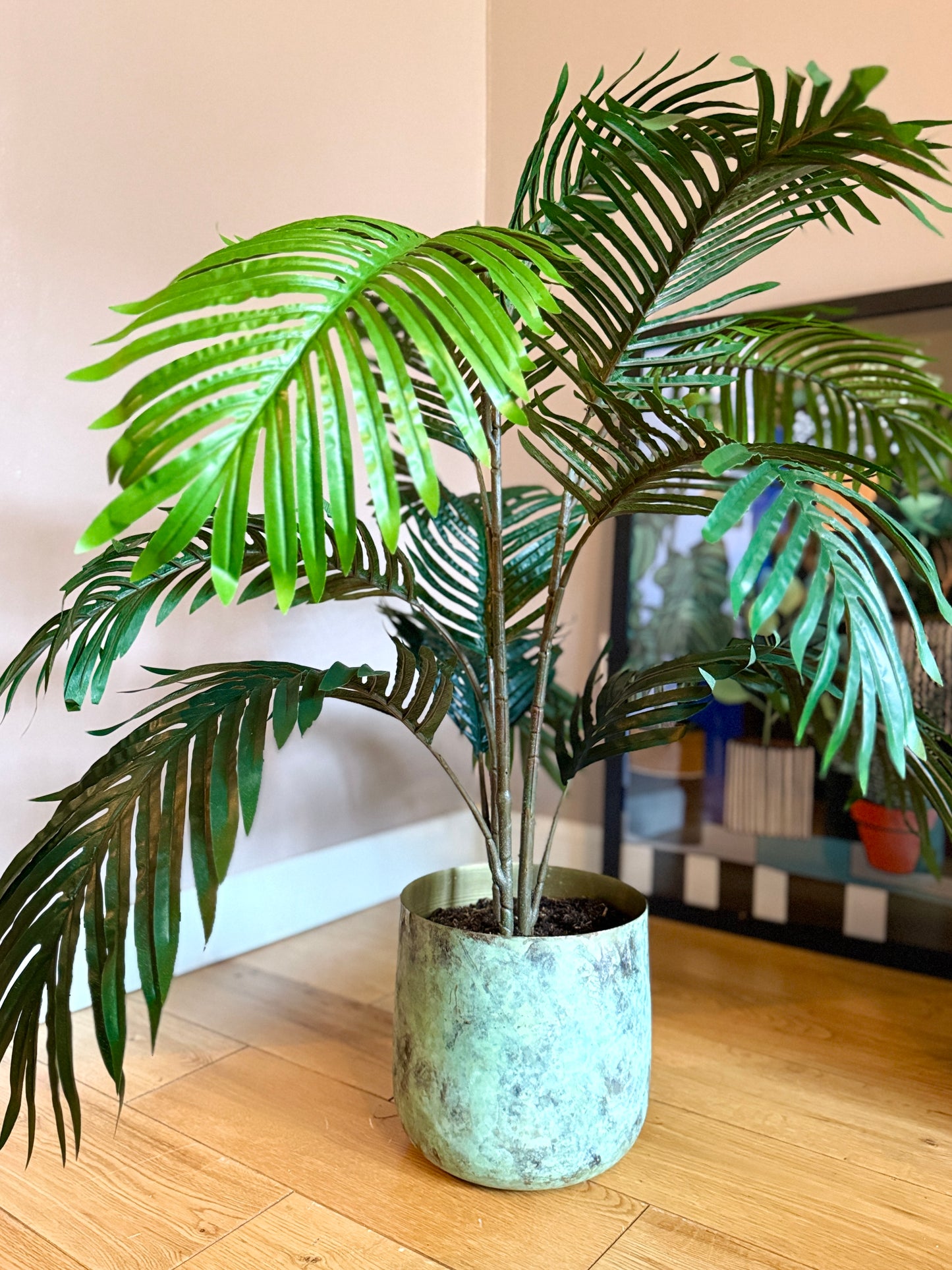 Front view of the Plantish artificial Areca Palm with detailed dark green fronds and simple stems, displayed in a modern pot. This lifelike plant brings a tropical vibe to any home or office, offering a low-maintenance, realistic alternative to real plants.