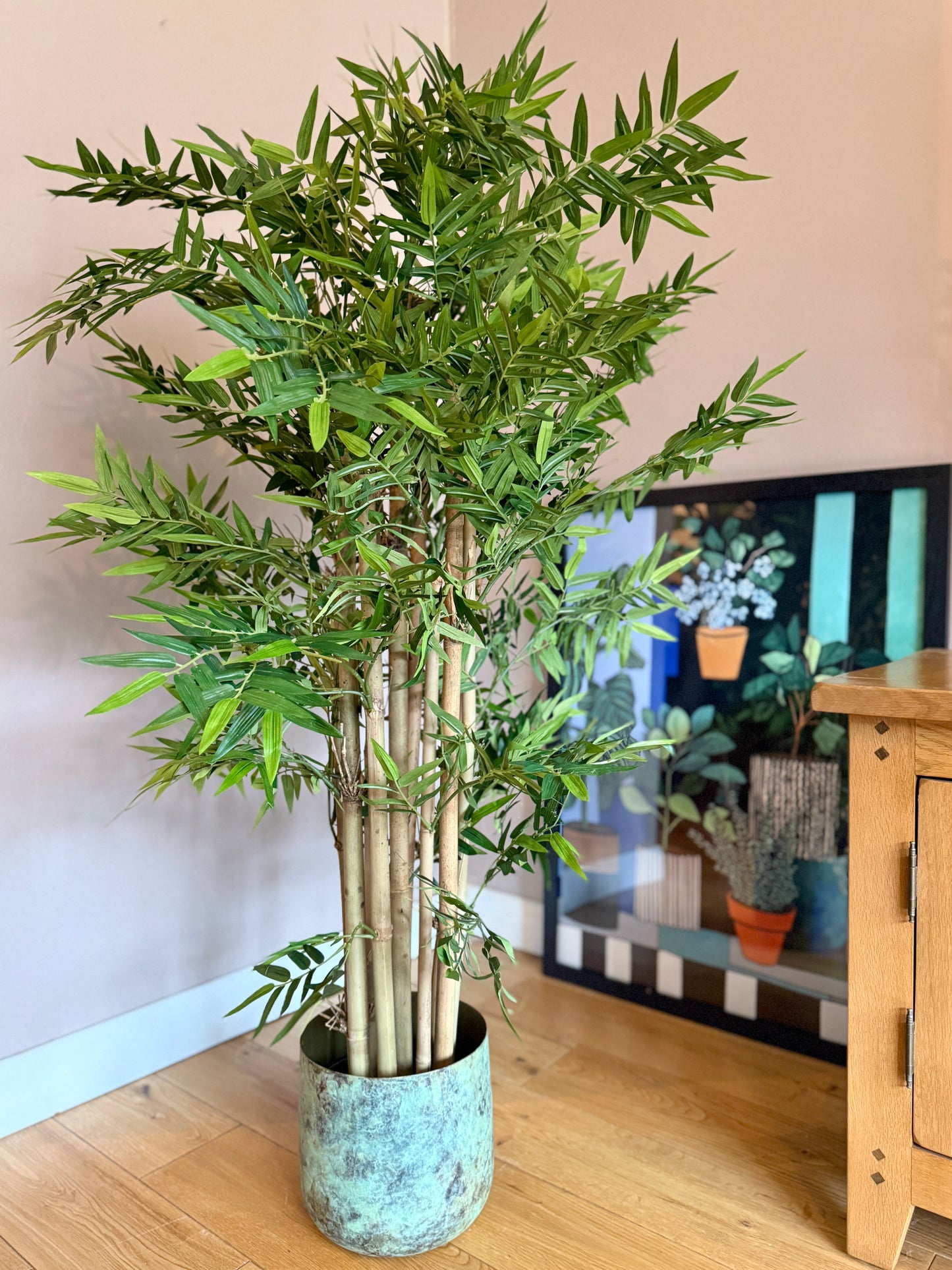 Front view of the Plantish artificial Bamboo tree featuring real bamboo stems and ultra realistic green leaves. This lifelike tree brings a natural, zen inspired touch to any space, offering a tall, maintenance free alternative to a real bamboo plant.