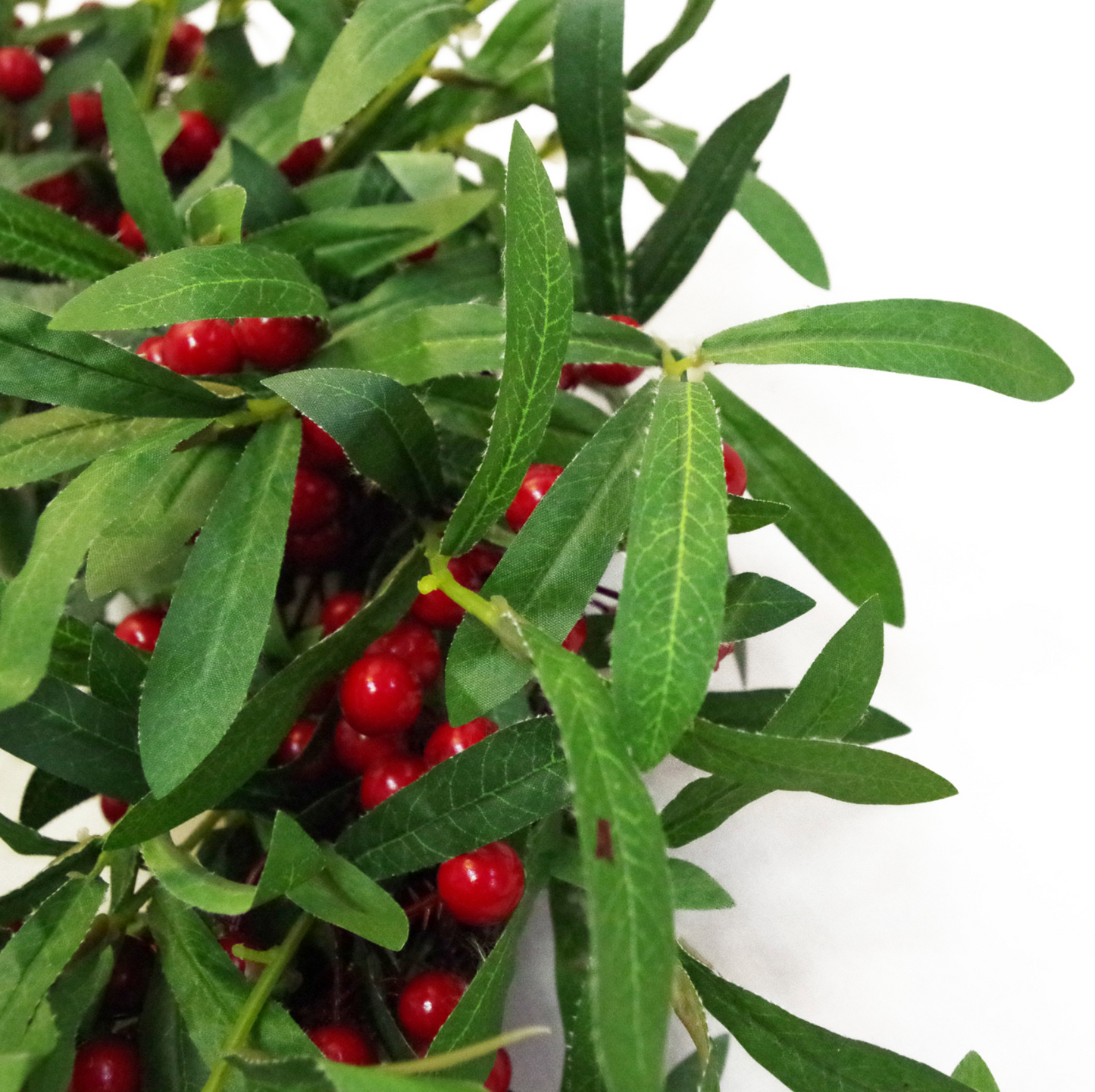 A close up of the Plantish 60cm Festive Mistletoe Wreath, highlighting the deep green mistletoe leaves and red berries in detail.