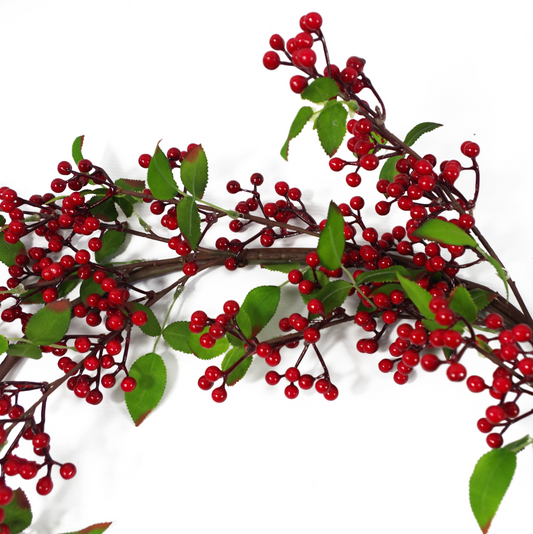 A close up of the Plantish Festive Red Berry Garland showing the dark red berries, green leaves, and shapeable wrapped wire in detail.