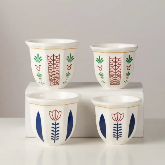 All four variants of the Plantish Floral Espresso Cup Set, with the Flower and Leaf designs in two sizes. The cups with Leaf design are on a white shelf.