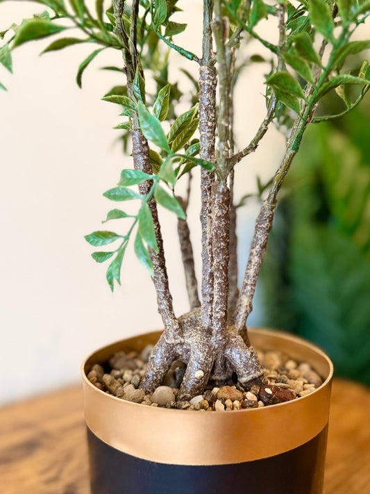 Back view of the Plantish artificial Nandina Ficus Bonsai, highlighting the black pot topped with decorative stones and the detailed trunk.