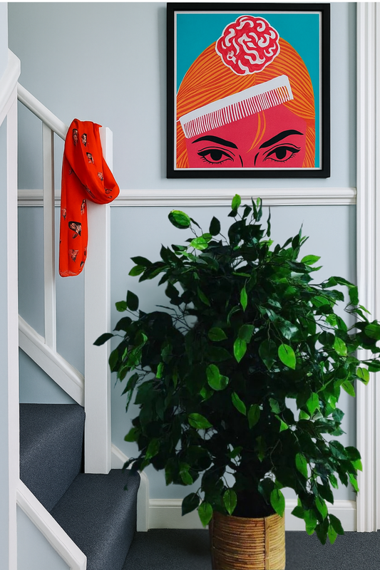 The Plantish ficus tree placed in a modern hallway at the bottom of a carpeted set of stairs, potted in a bamboo pot and showing the green leaves.
