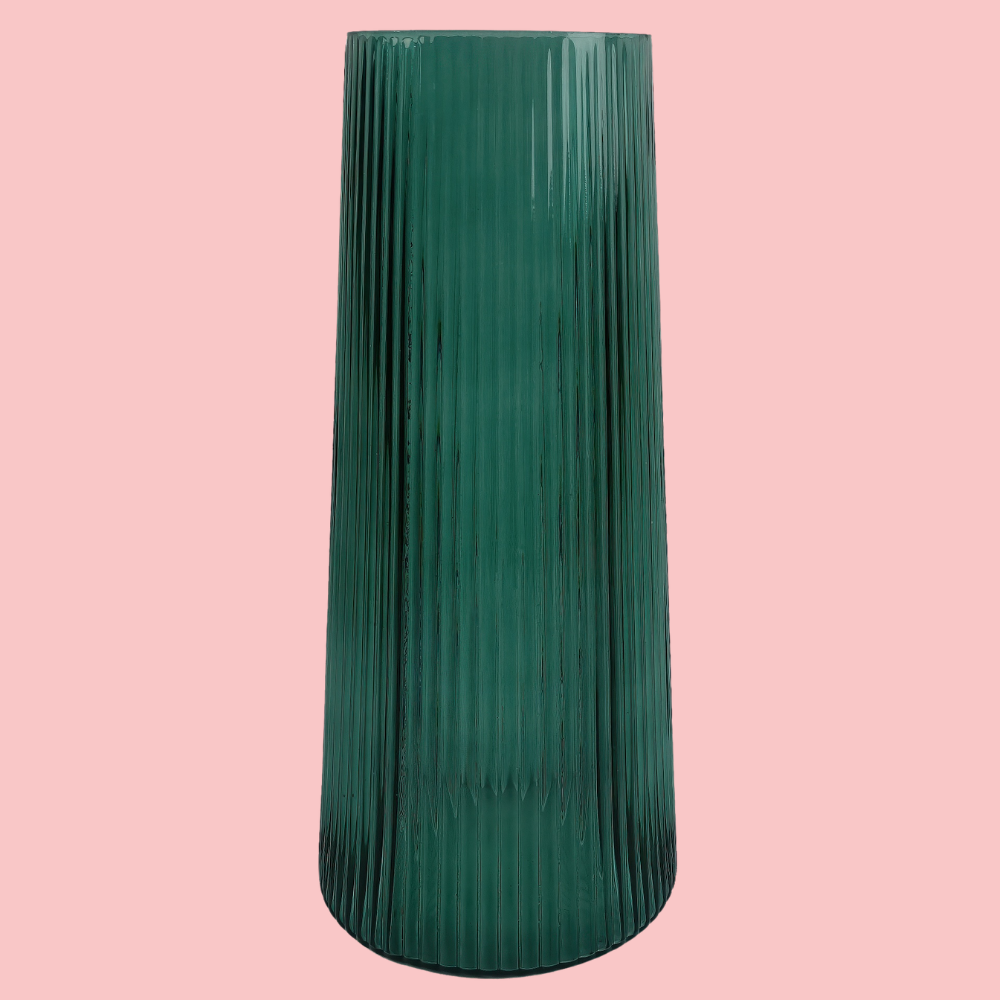 Front view of the Plantish Green Ridged Vase, highlighting the vertical ridge design. Shown on a block pink background.