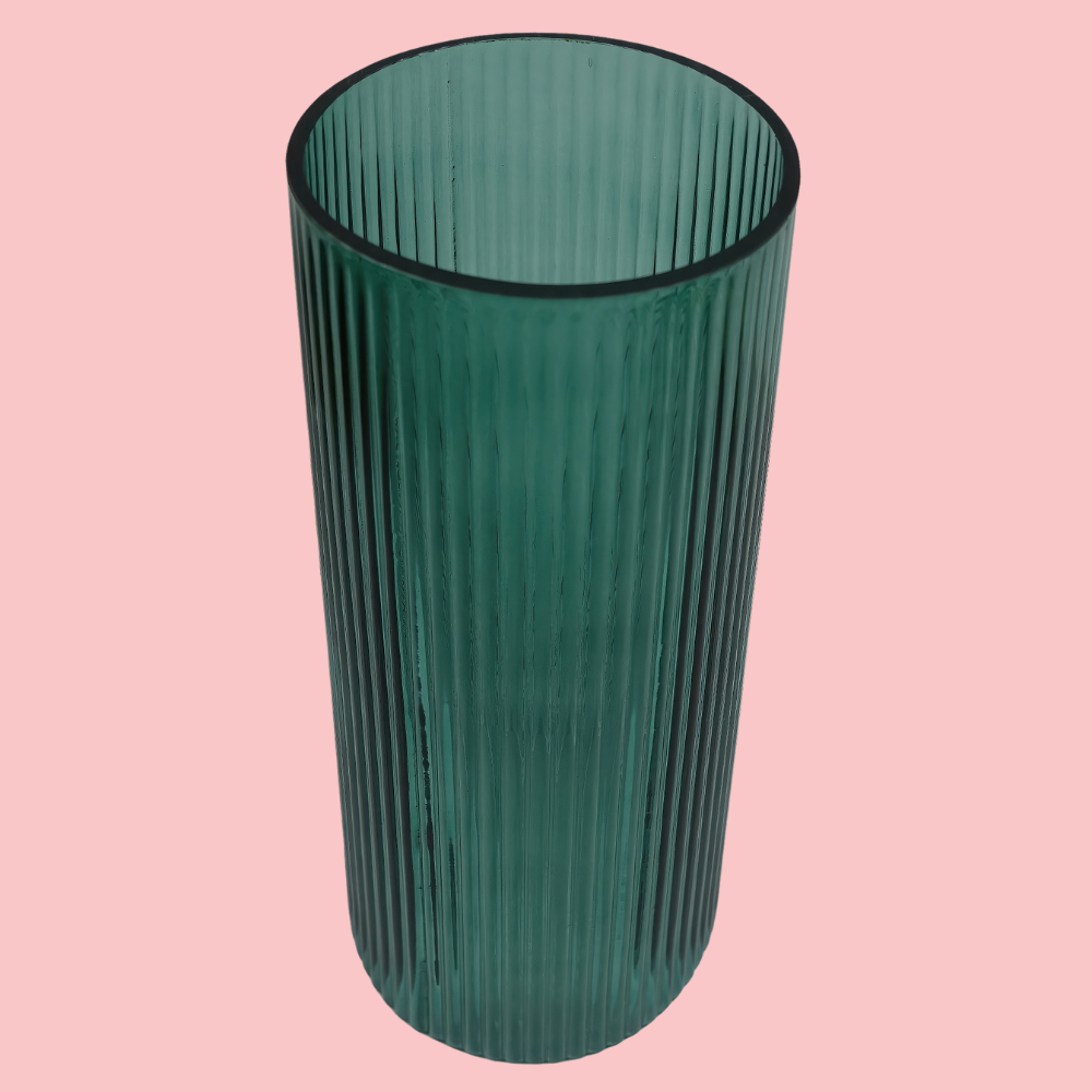 Top view of the Plantish Green Ridged Vase, highlighting the vertical ridge design. Shown on a block pink background.