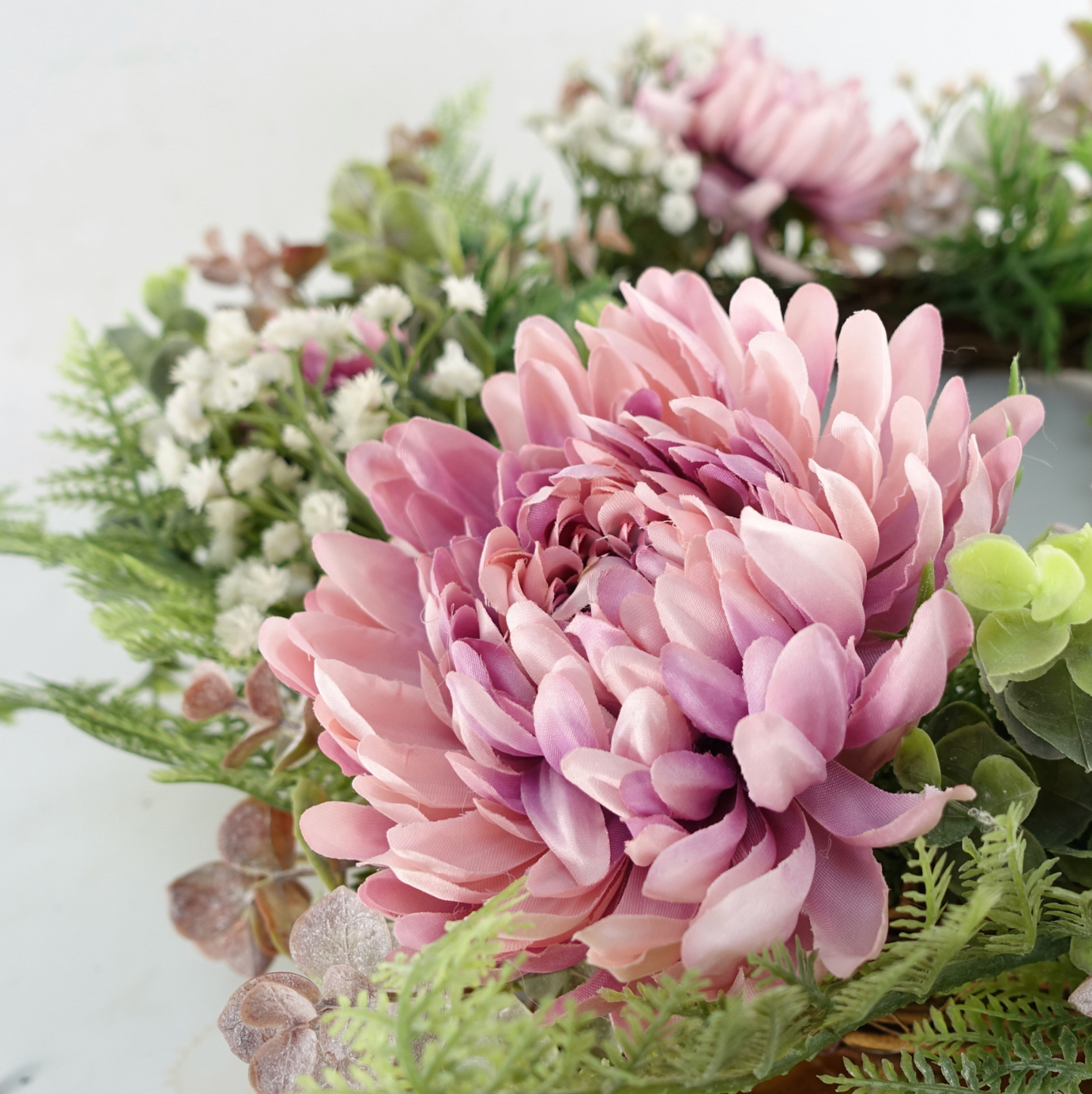 A close up of the Plantish 45cm Pink Peony Wreath highlighting the detail of the Pink Peony flower and greenery.