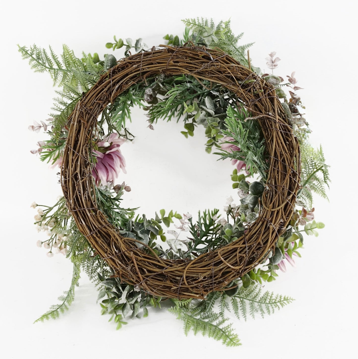 The Plantish 45cm Pink Peony Wreath shown rear-on, highlighting the natural woven ring, pink peonies, green leaves and fronds, and small white flowers.