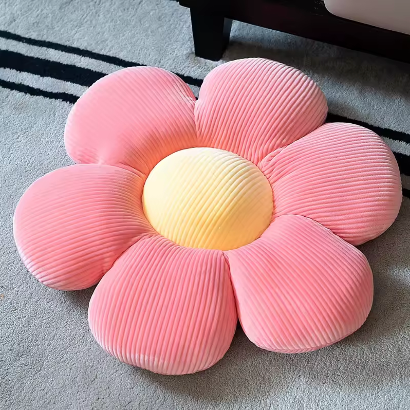 The Plantish Flower Plush Pillow in its Pink/Yellow colour variant. The pillow is flower shaped with the petals being pink and the centre yellow.