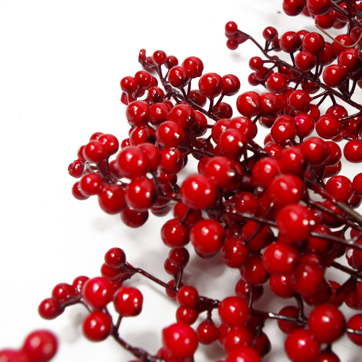 A close up of the Plantish 60cm Red Winter Berry Wreath, showing the red berries in high detail.