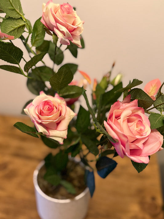 Close up of the Plantish artificial pink rose, highlighting the soft, layered petals and intricate detailing for a lifelike, natural look.