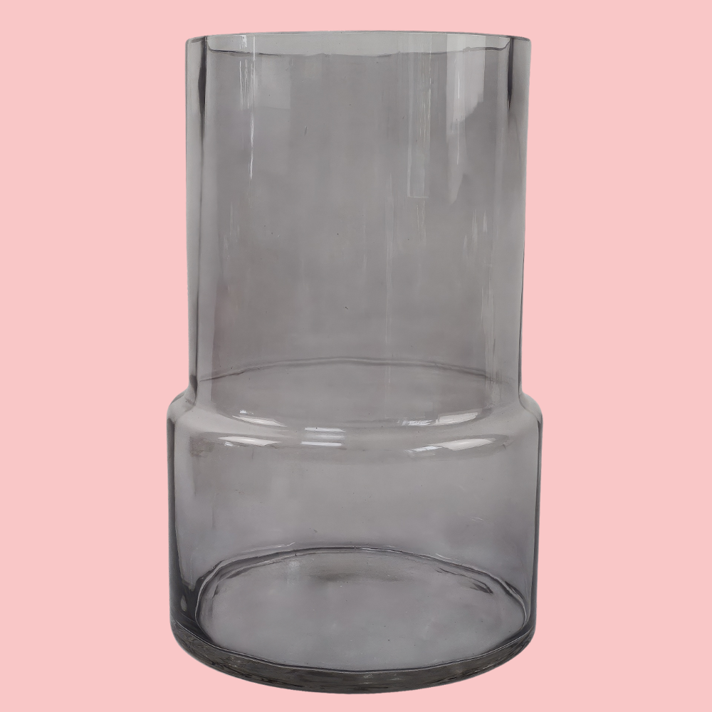 Front view of the Plantish Smoky Vase, made of smoked glass. Shown on a block pink background.