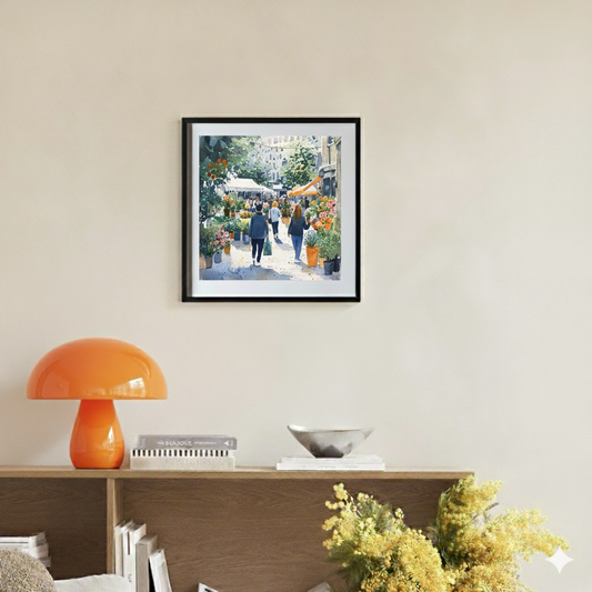 A vivid watercolour print of a busy city flower market full of green plants, vibrant blooms and people, in a bright contemporary room