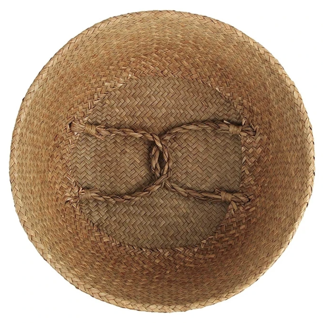 A top down view of the Plantish Woven Wicker Basket, showing the inside of it when folded down to half height. The handles are inside.