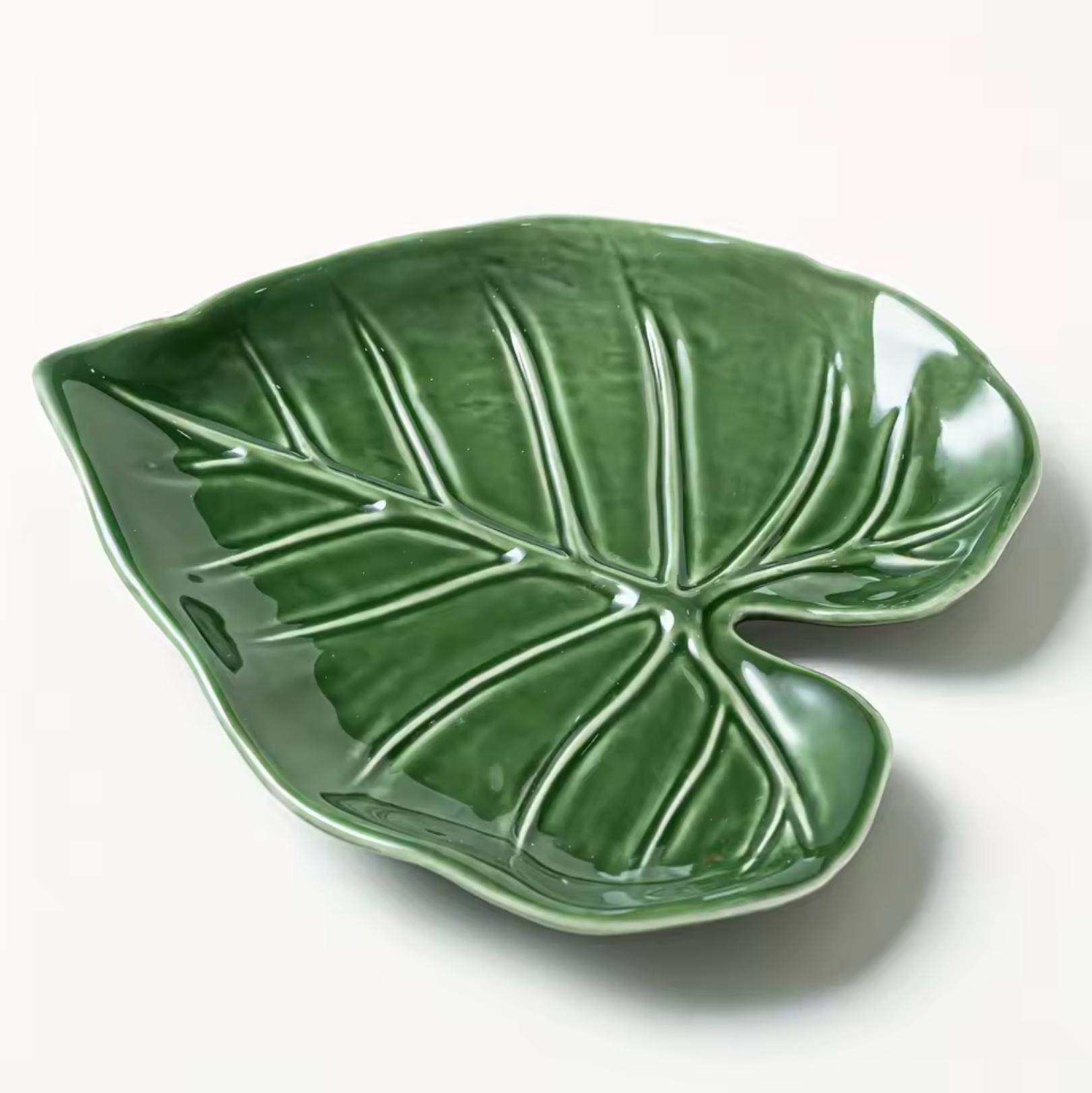 The Plantish Alocasia Leaf Ceramic Dish on a white background, highlighting the nuanced green colours and textures of the  tray. 