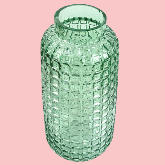 Top view of the Plantish Cube Vase, made of teal coloured glass with a textured cube design. Shown on a block pink background.