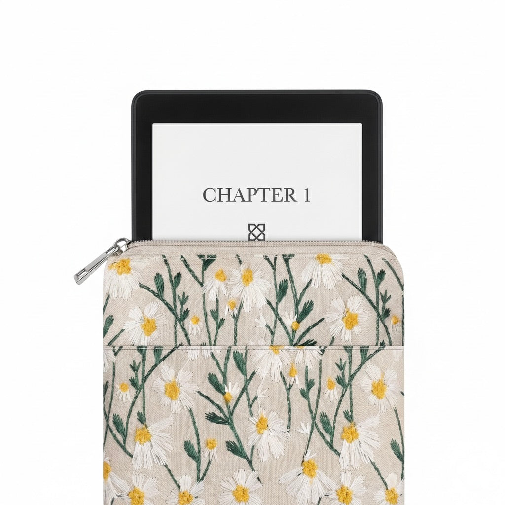 An image of the Plantish Embroidered Floral E-Reader Case which has a device halfway out of the sleeve. The case and kindle are on a white background.