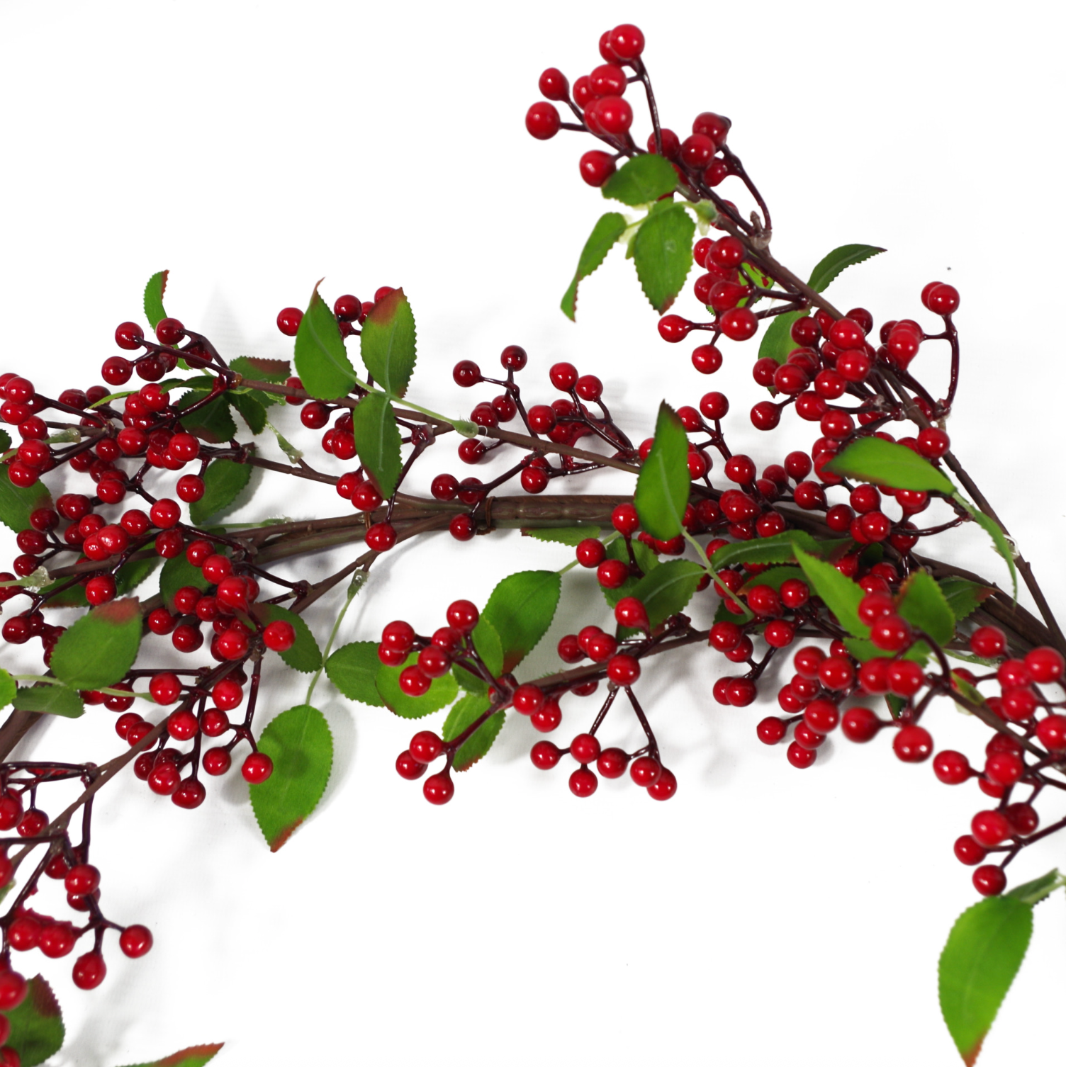 A close up of the Plantish Festive Red Berry Garland showing the dark red berries, green leaves, and shapeable wrapped wire in detail.