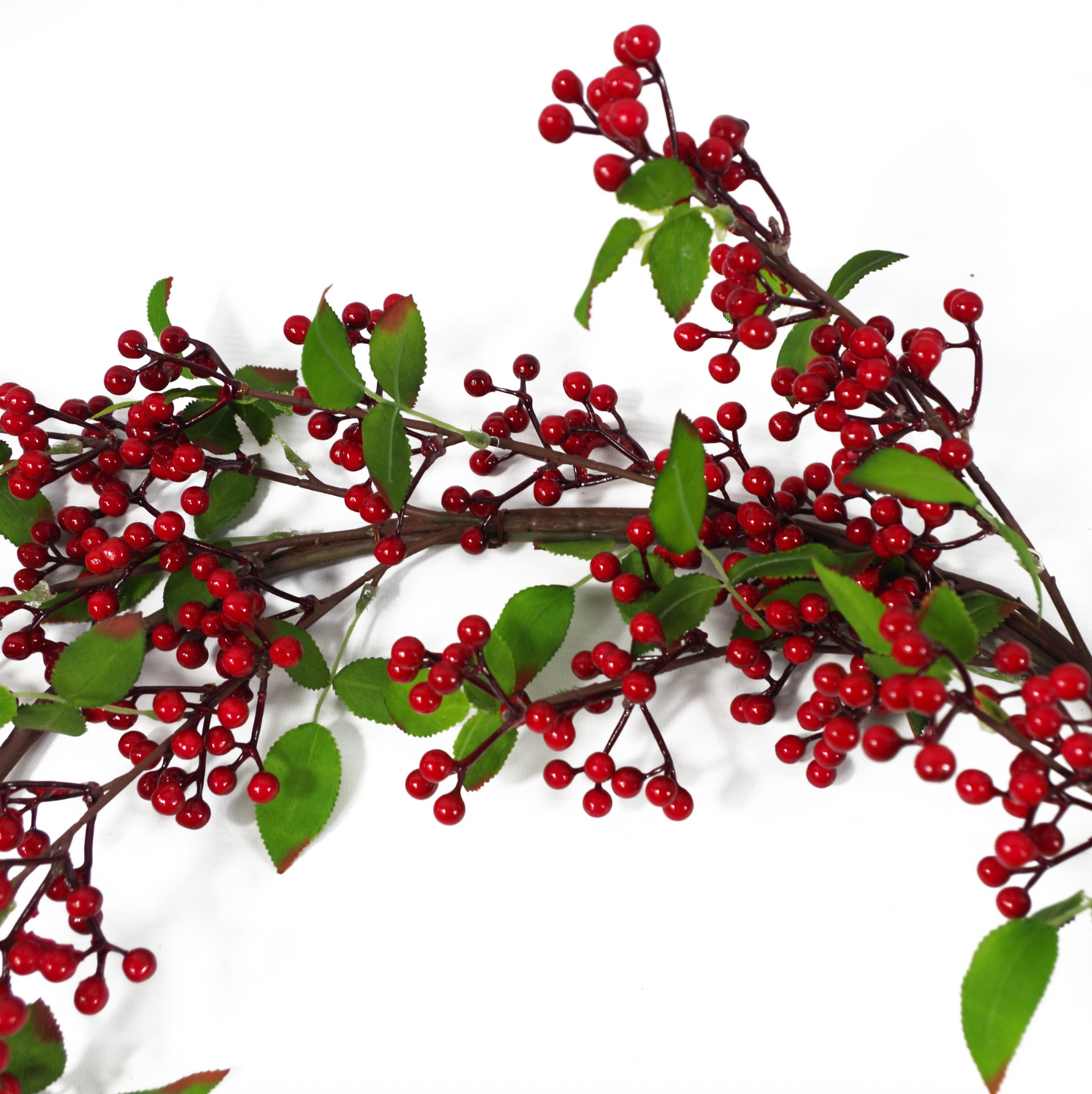 A close up of the Plantish Festive Red Berry Garland showing the dark red berries, green leaves, and shapeable wrapped wire in detail.