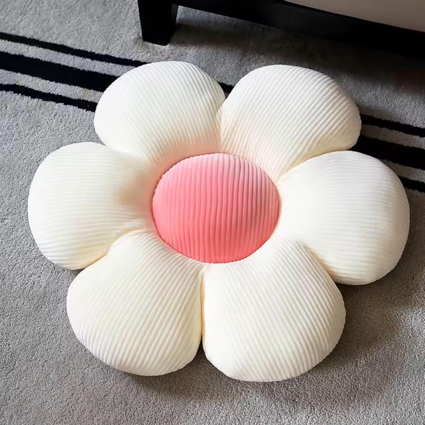 The Plantish Flower Plush Pillow in its 
White/Pink colour variant. The pillow is flower shaped with the petals being white and the centre pink.