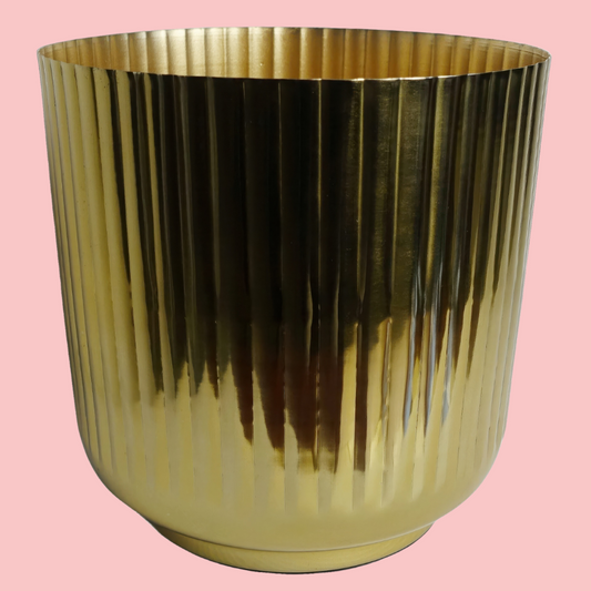 Top view of the Plantish Gold Ridged Metal Pot, highlighting the vertical ridge design, shown on a block pink background.