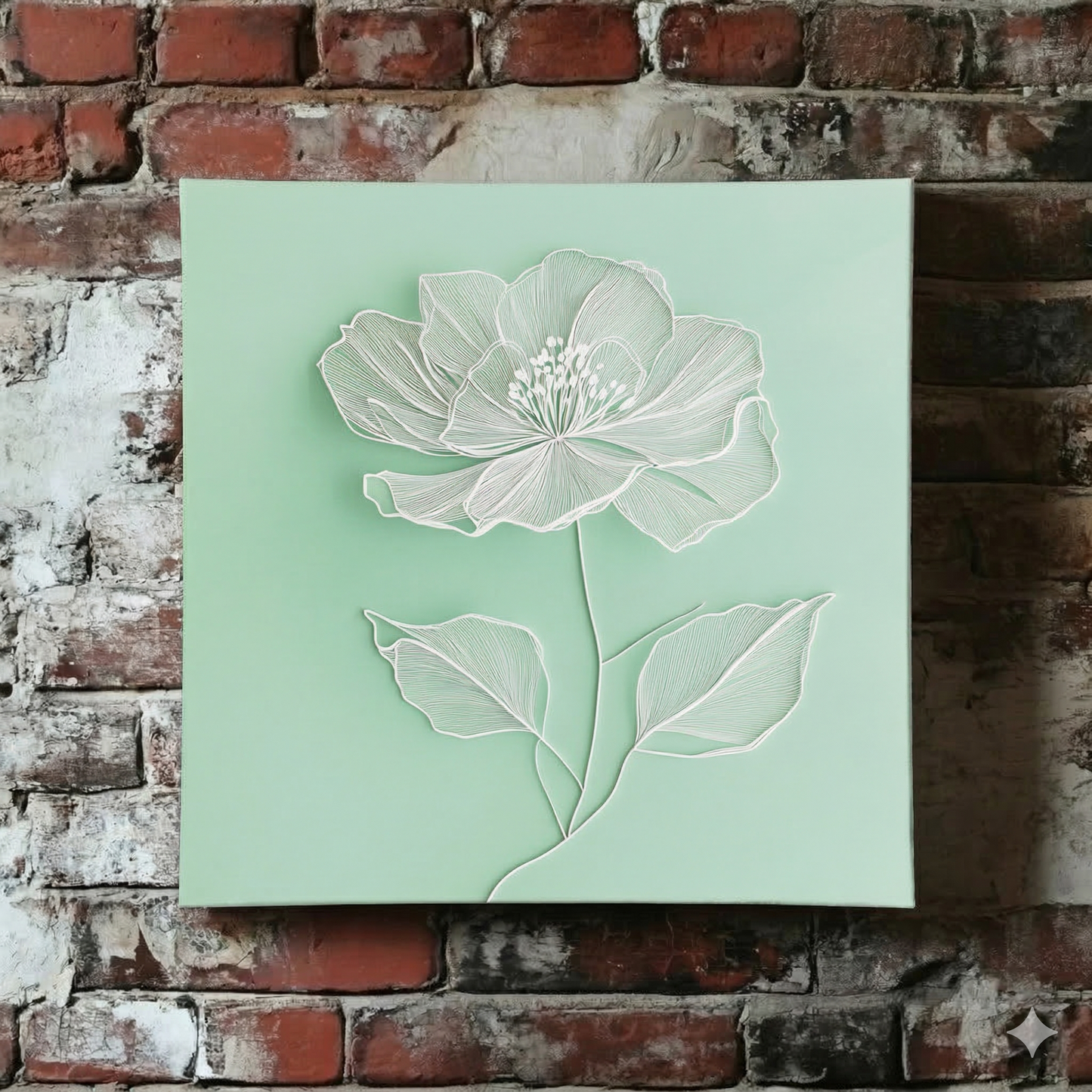 A bright Plantish canvas of a white line drawn poppy flower on a calming light green background, shown hanging on a red brick wall.