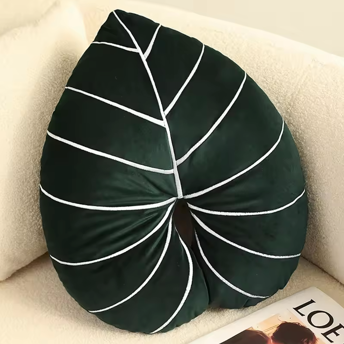 The Plantish Jungle Leaf Cushion Philodendron design. Shown in the corner of a white sofa, and highlighting the front design of the leaf cushion