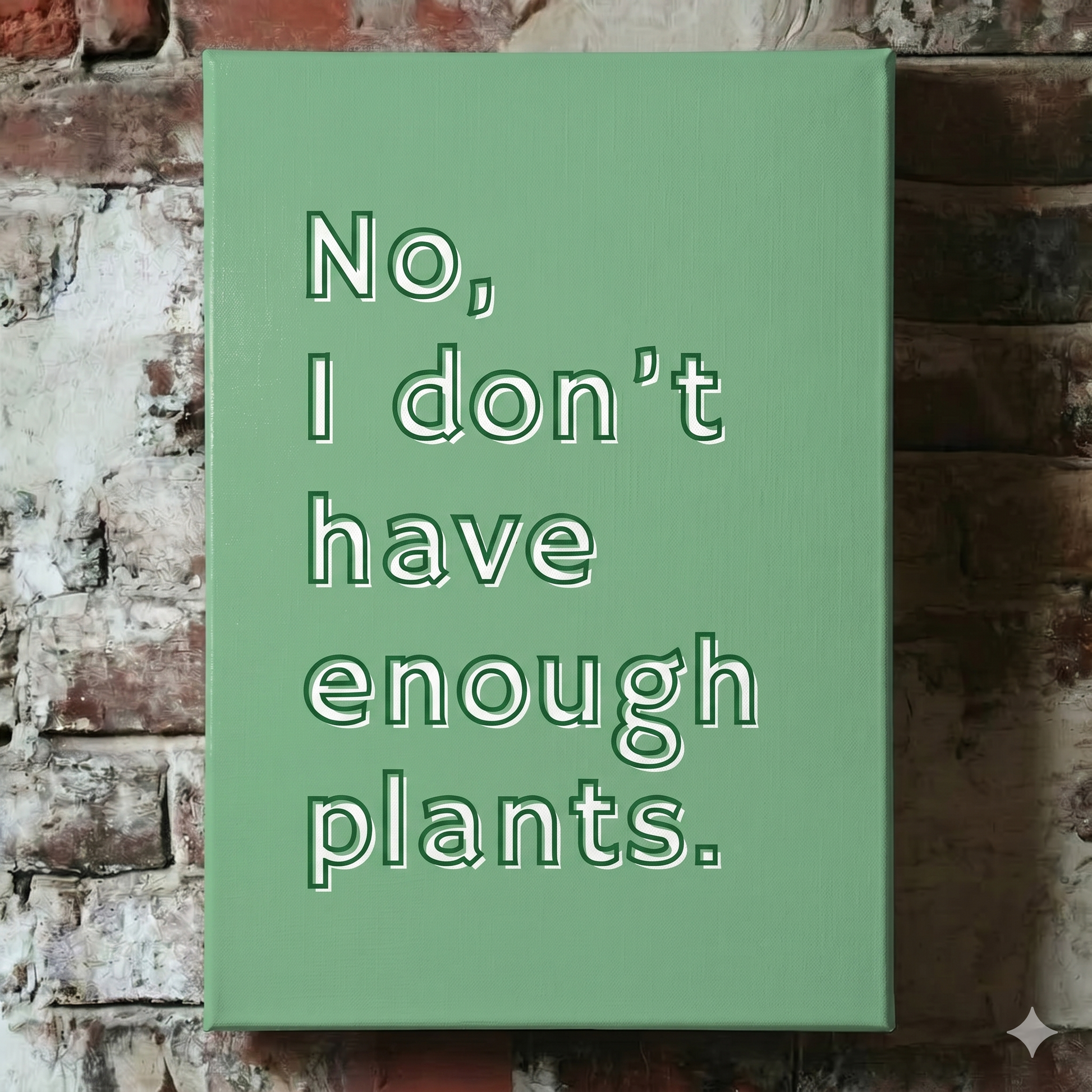 A Plantish canvas of the phrase "No I Don't Have Enough Plants" in a white font with green background, shown hanging on a red brick wall.