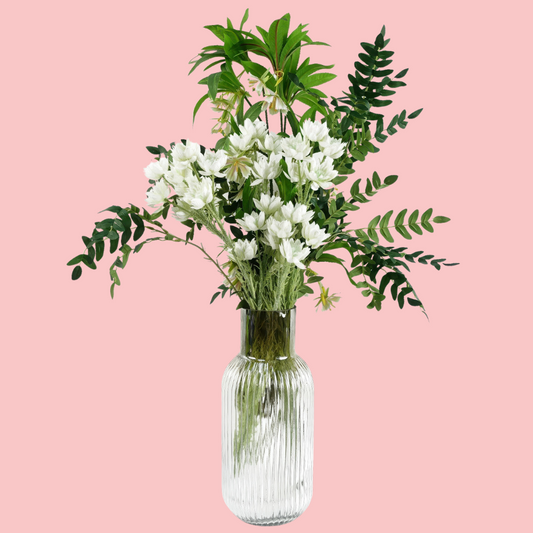 Side view of the Plantish Ombre Vase, made of clear glass with chestnut colouring on the neck, and vertical ridge design. Shown with artificial flowers and on a block pink background.