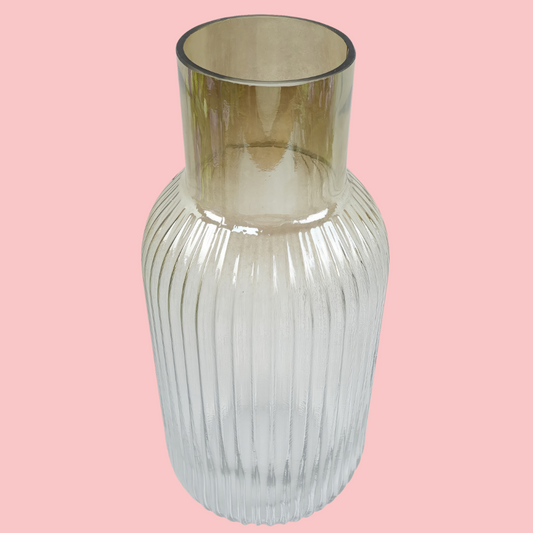 Top view of the Plantish Ombre Vase, made of clear glass, chestnut colouring around the neck and a vertical ridge design. Shown on a block pink background.