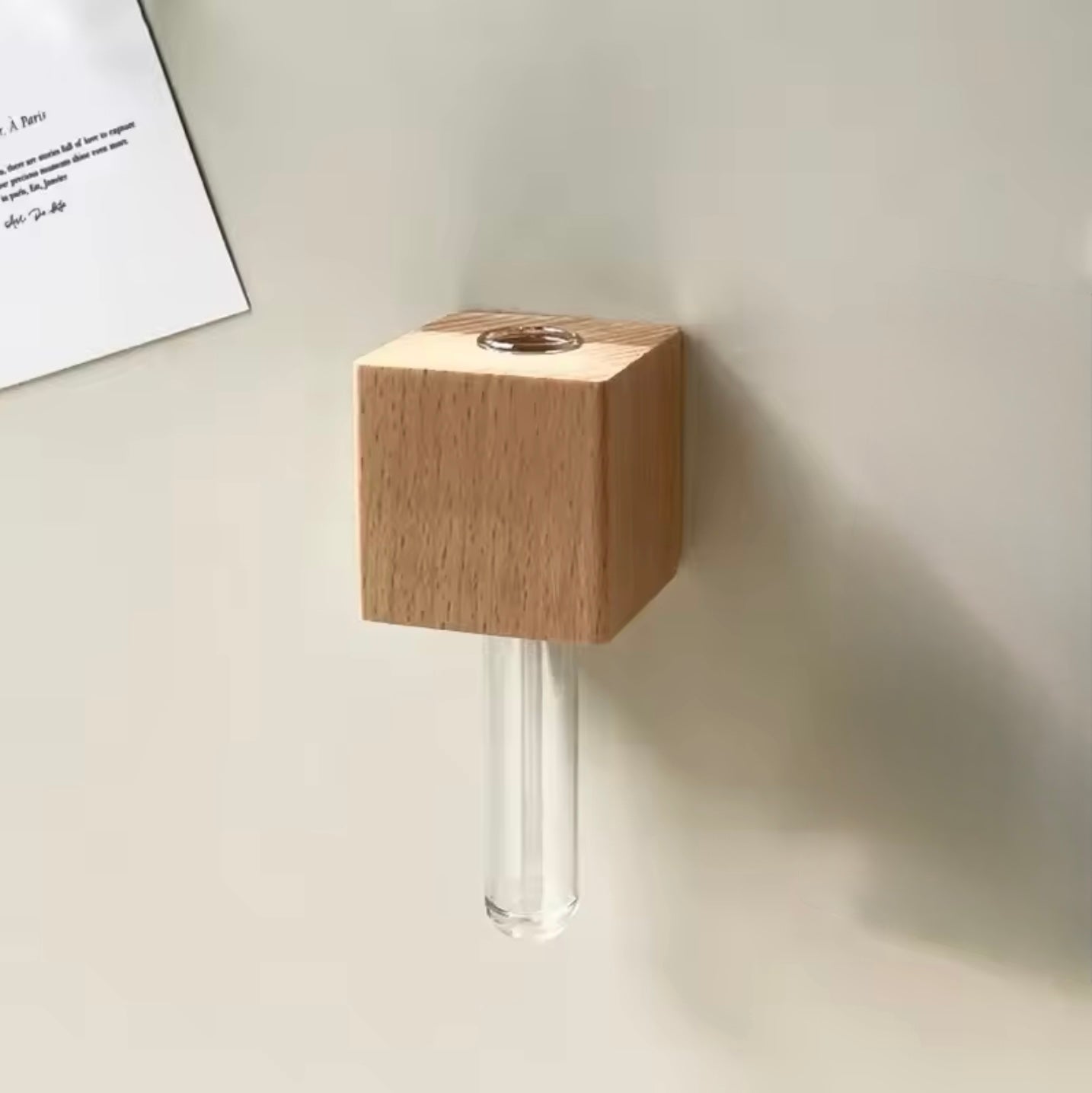 The Plantish Propagation Fridge Magnet in the Light Wood variant, shown empty and attached to a fridge. The glass vial is shown up close.