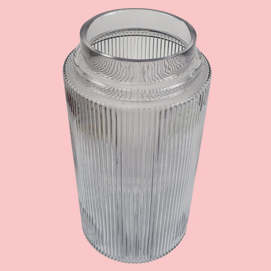 Top view of the Plantish Ridged Vase, made of clear glass, highlighting the vertical ridge design. Shown on a block pink background.