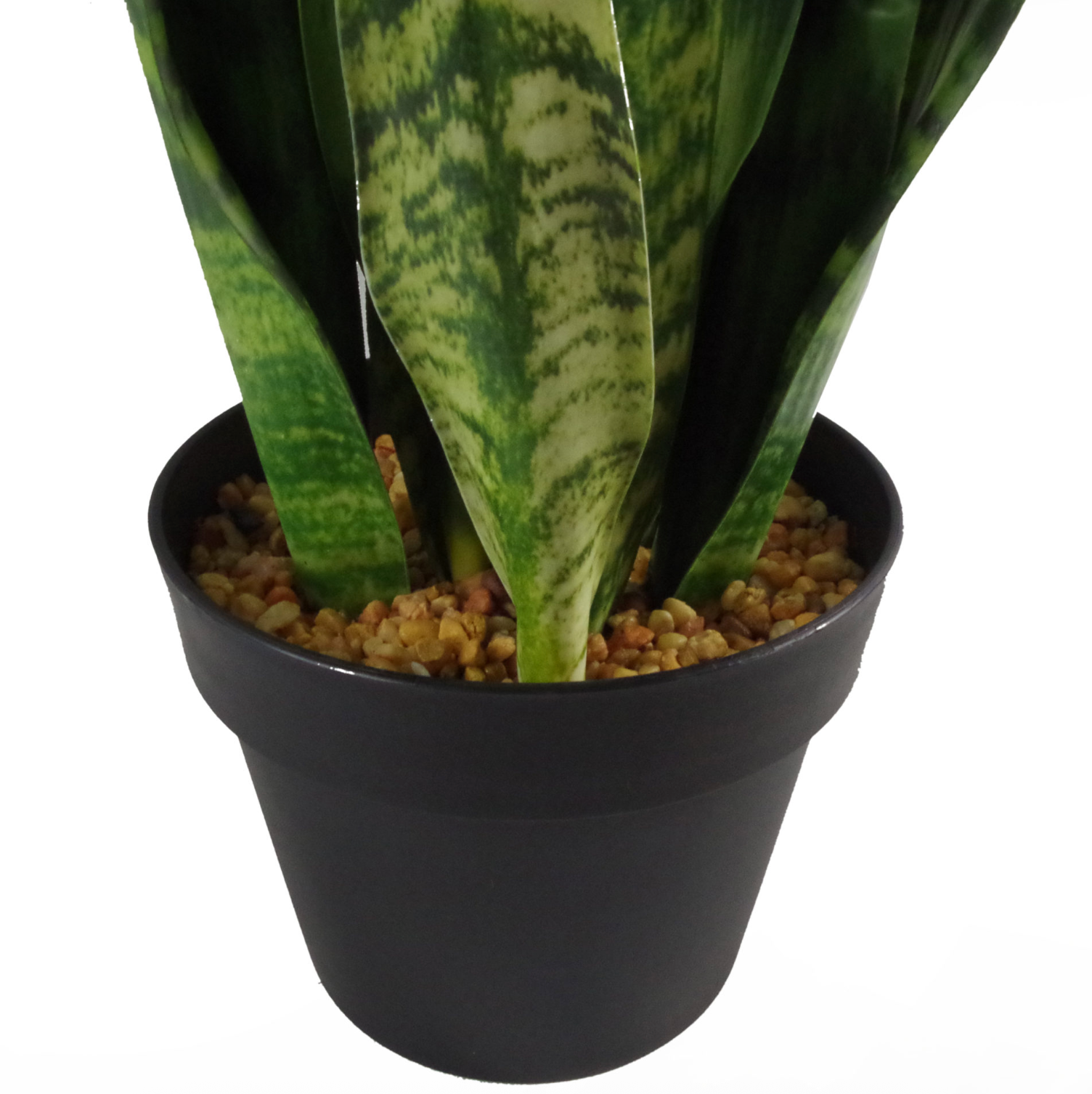 A close up of the base of the Plantish artificial snake plant sansevieria highlighting the black plastic pot topped with stones as well as the green stems. 