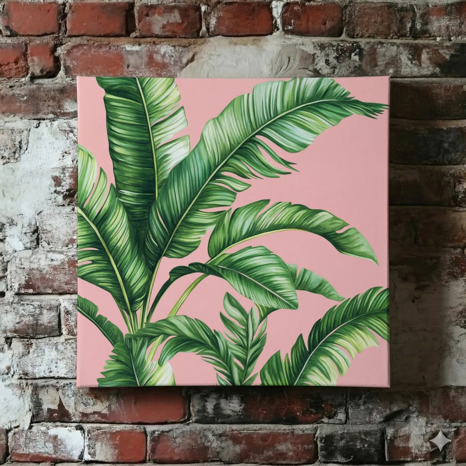 A Plantish canvas of stylised green palm leaves against a pastel pink background, shown hanging on a red brick wall.